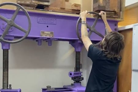 Veneer press being used be a furniture student 