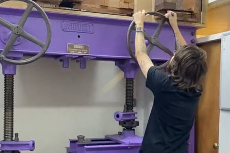 Veneer press being used be a furniture student 