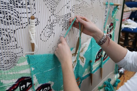 Emma Straw weaving 'The Empress of the Insects' at West Dean Tapestry Studio 