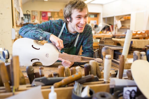 Student making stringed instrument at West Dean College of Arts and Conservation