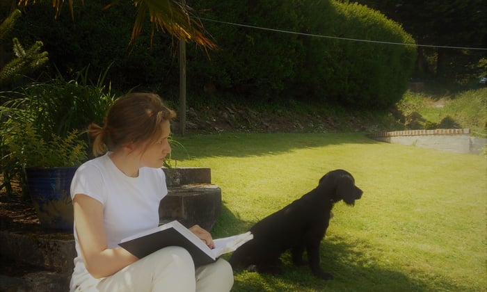 Joanna Biggs is stiing on grass with her dog
