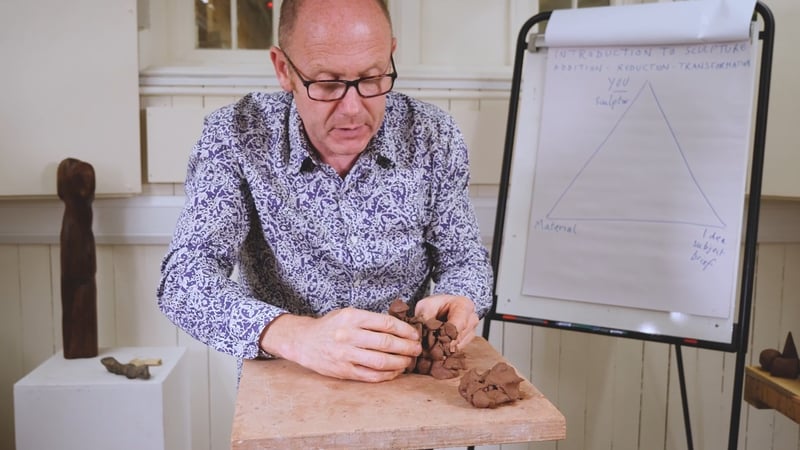 Tutor Jon Edgar moulding a shape in clay