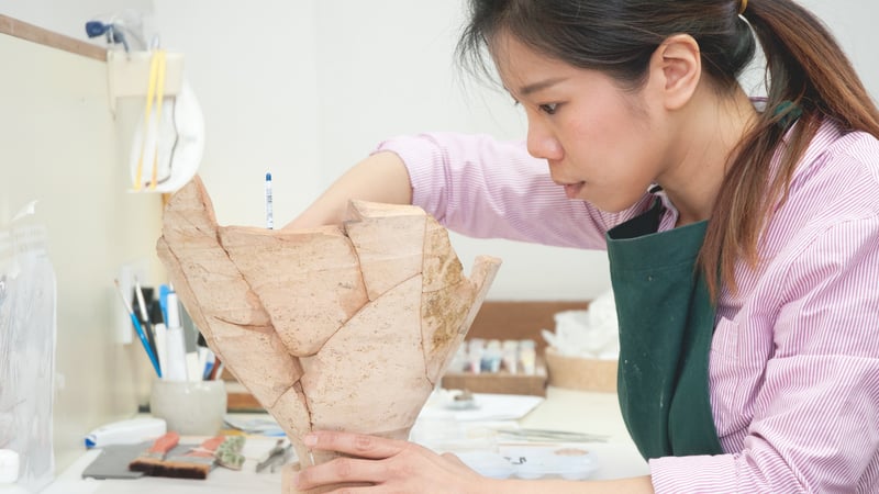 Student Conserving a ceramic pot at West Dean College of Arts and Conservation