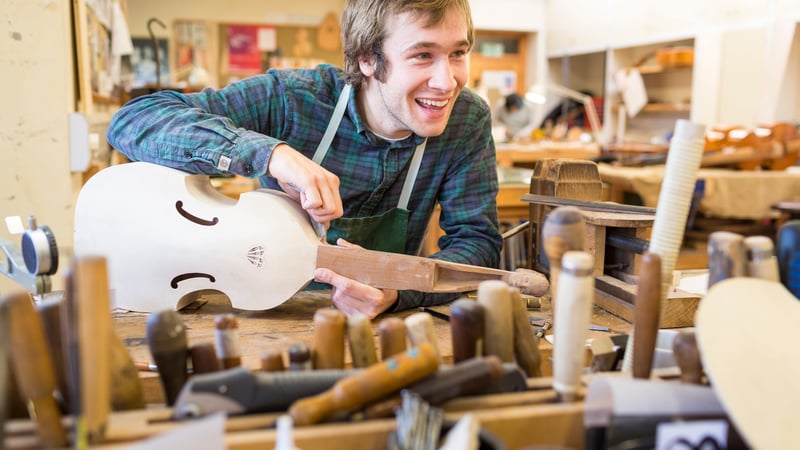 Student making musical instrument in the workshop at West Dean College