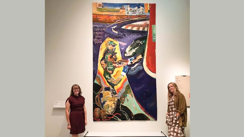 Weavers Emma Straw and Jo Howard with the Michael Armitage tapestry in the National Portrait Gallery. Image credit: Michelle Ussher