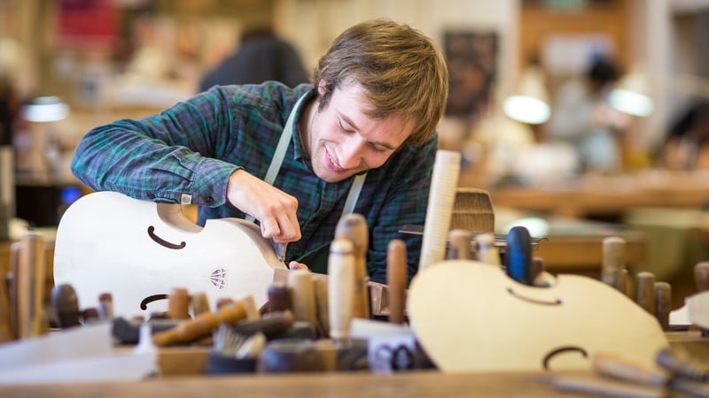 Student making musical instrument at West Dean College of Arts and Conservation