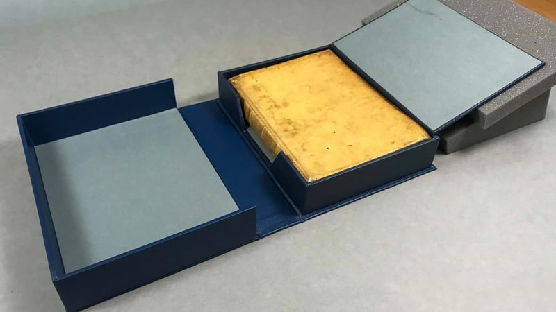 Completed parchment binding inside a custom made pressure box