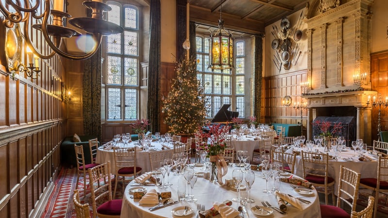 Tables laid in the Oak Hall at Christmas at West Dean College of Arts and Conservation