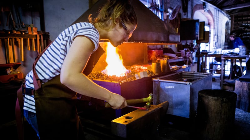 Student doing blacksmithing in the forge