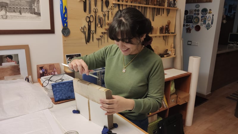 Maria Borg discovered a thick layer of adhesive on the spine during conservation treatment. The adhesive hampered the movement of the spine. We can remove the old adhesive and improve the spine's flexibility by applying a water-based poultice to the glue.