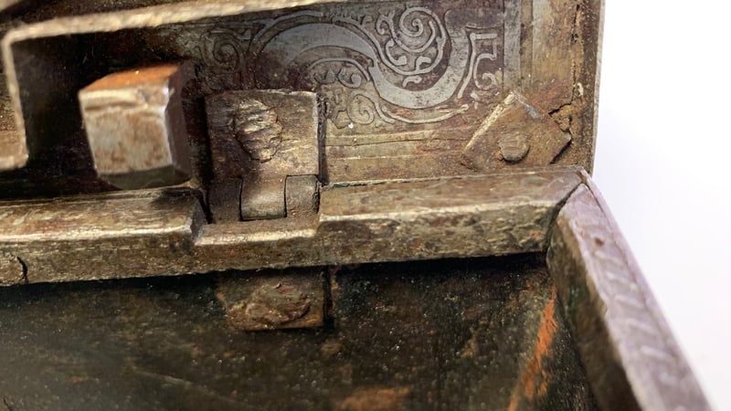 Fig 11. Close up of an affected corner of the lid, showing light powder corrosion and degraded waxy residue. 