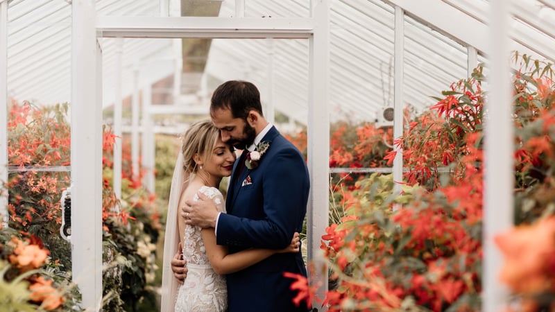 Bride and groom in the glasshouse at West Dean Gardens. Credit Esme Ducker Photography