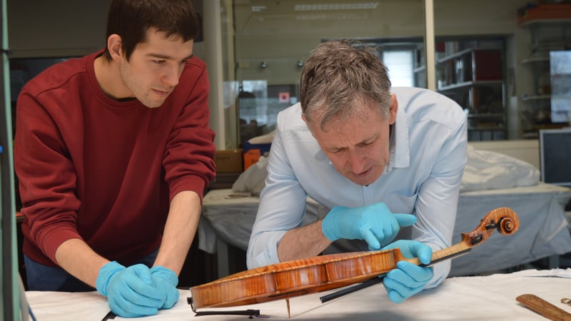 Boris and Shem examining the Stradivarius.