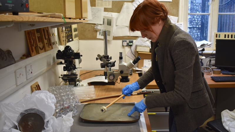Mary Hampton testing the acoustic qualities of the Batterie de Cuisine, with beater 