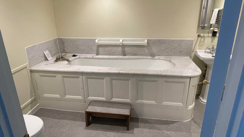 The marble-topped bath