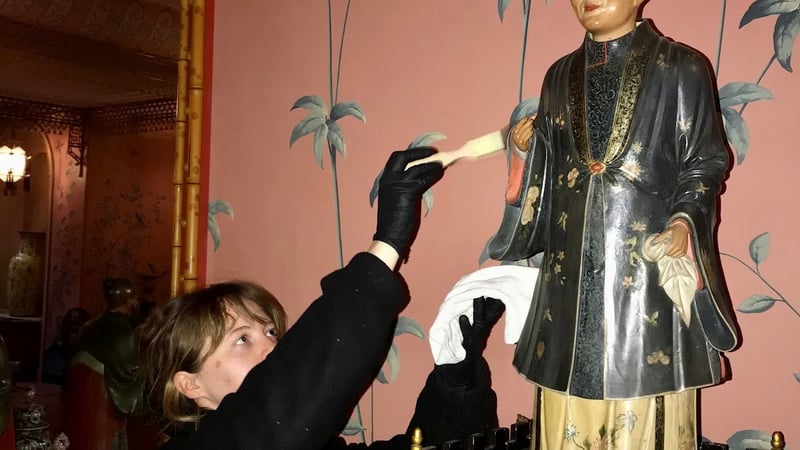 Cleaning of one of the long galleries nodding figures using a soft bristled brush and micro fiber cloth. 