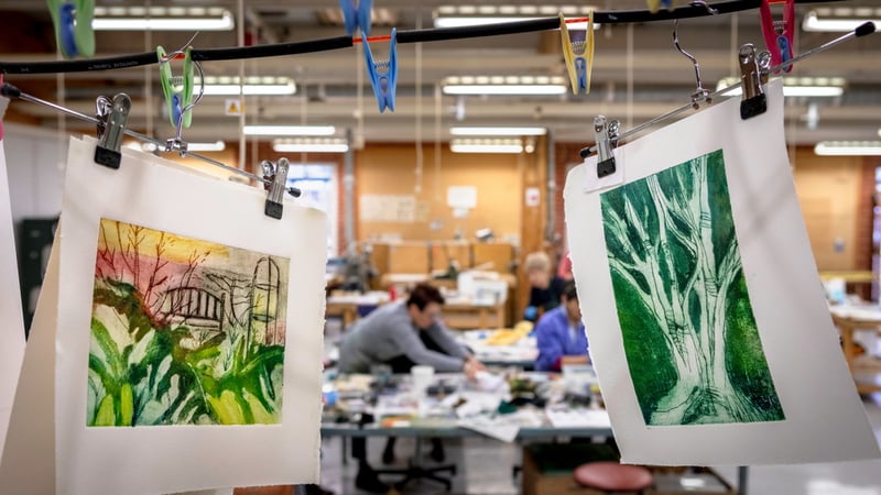 Prints hanging to dry with students working in the background. Photo credit Chris Ison