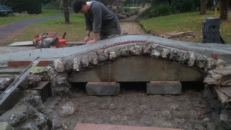 Jim Buckland building flint bridge at West Dean Gardens
