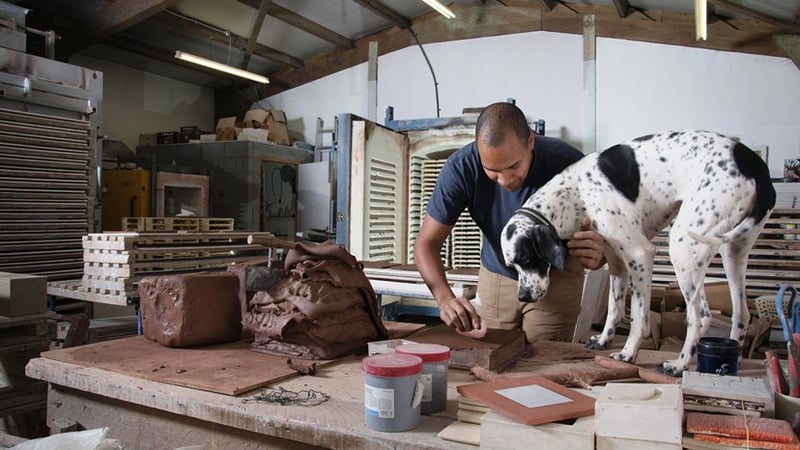 Tile maker, Richard Miller, in his studio, with friend