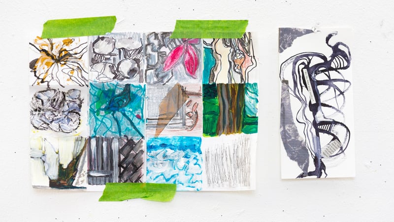 Colourful mixed-media sketches pinned to a white wall
