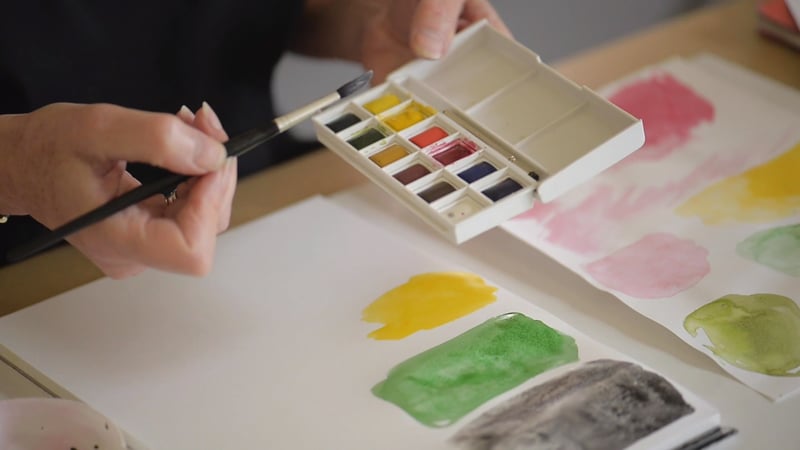 A close-up of a colour mixing exercise using watercolour paints