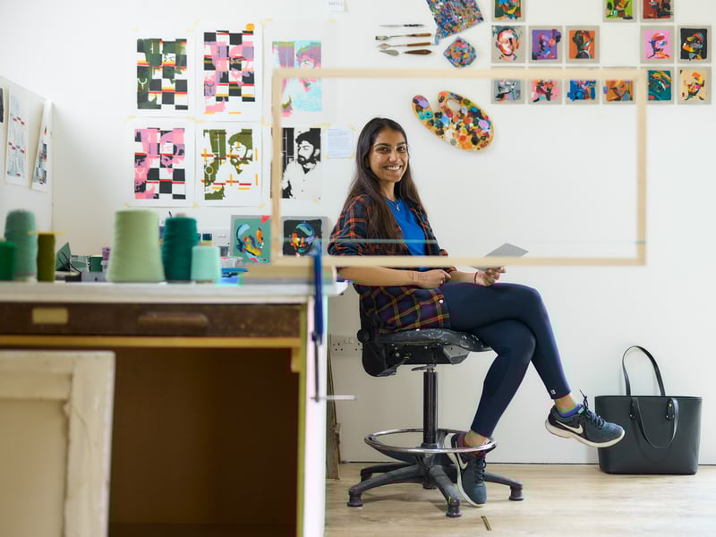Arts student sits in studio at West Dean College
