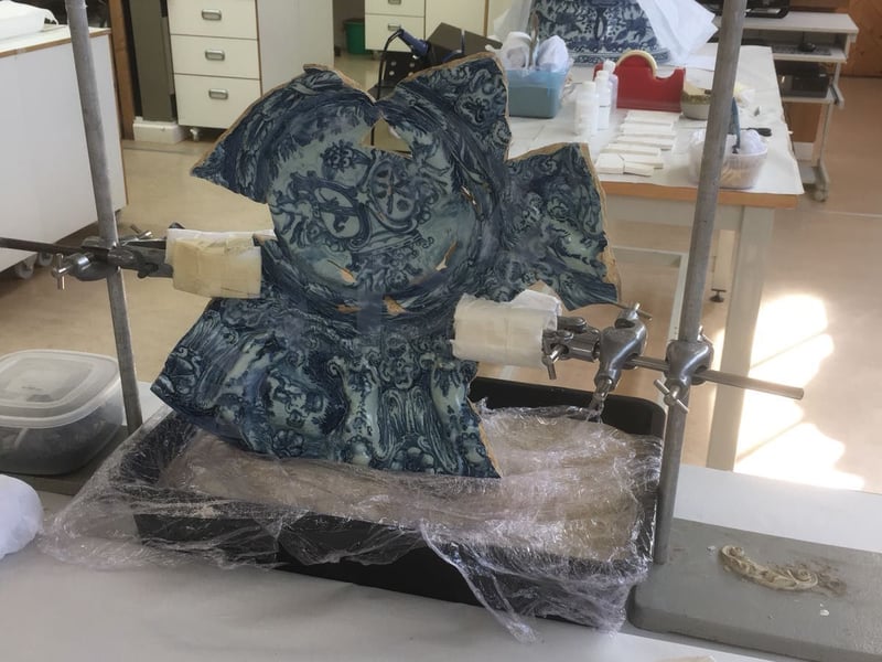 Support system during bonding process of maiolica dish at West Dean College of Arts and Conservation