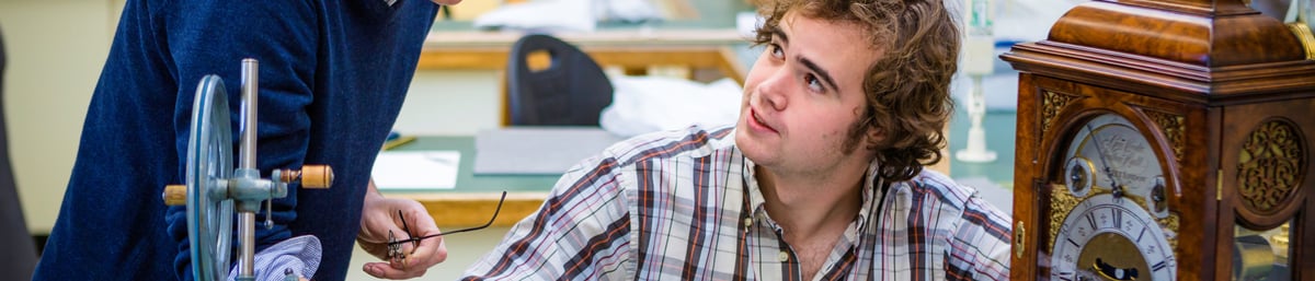 Malcolm Archer Subject Leader Clocks talking to a student 