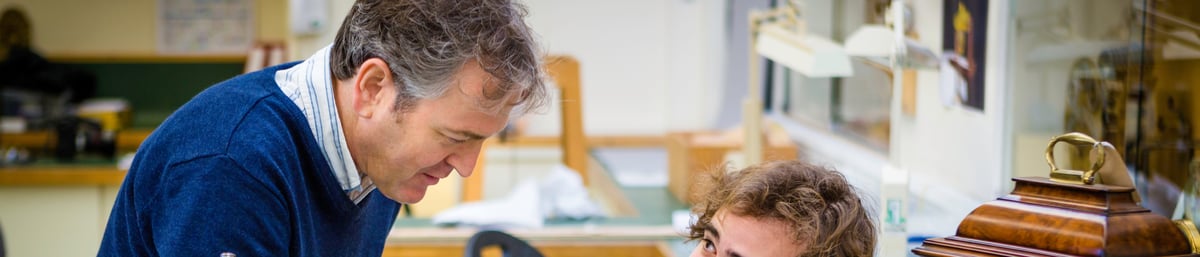 Malcolm Archer Subject Leader Clocks talking to a student 