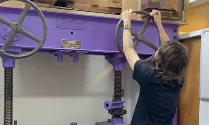 Veneer press being used be a furniture student 