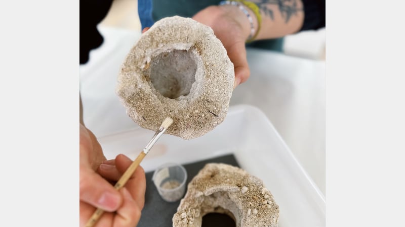 Ceramics Student Lucie, working on a beehive