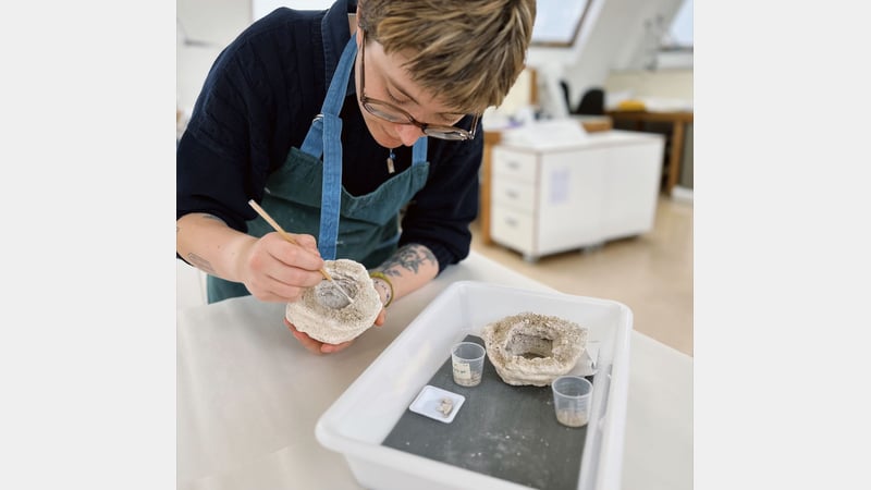 Ceramics Student Lucie, working on a beehive