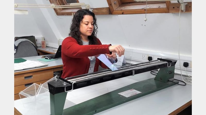 Book Conservation student works on perspex supports for the book