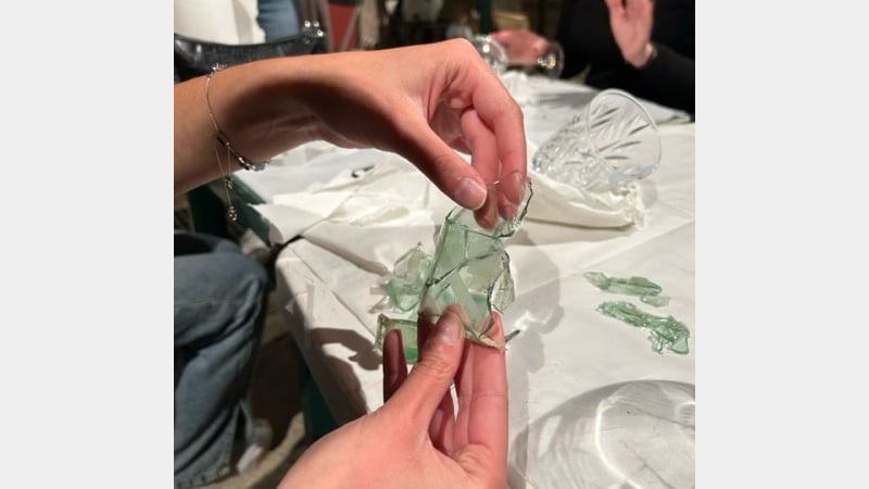A student working on a small square bottle