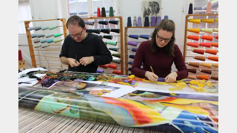 Weavers Philip Sanderson and Emma Straw weaving the Michael Armitage tapestry in the West Dean Tapestry Studio in 2022.